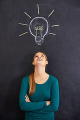 Image showing Idea, thinking and happy woman with light bulb on chalkboard for inspiration, brainstorming and problem solving. Creative, question and person on background for solution, thoughtful and planning