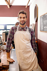 Image showing Man, barista and portrait in a coffee shop with smile for service, catering and job at restaurant. Waiter, person or entrepreneur in cafeteria with apron, food and happy for small business in Italy