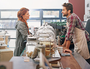 Image showing Woman, customer and waiter in a coffee shop, counter and decision for order, drink and smile in morning. People, man and service in a cafeteria with choice, happy and conversation for latte in Italy