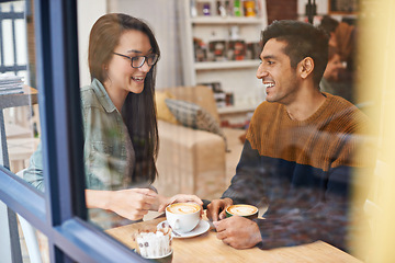 Image showing Happy couple, relax and date with coffee at cafe for conversation, bonding or romance at indoor restaurant. Man and woman with smile by window and enjoying drink, beverage or morning caffeine at shop