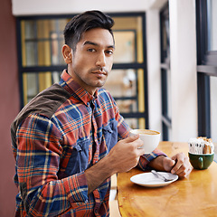 Image showing Man, portrait and cafe with coffee for morning, beverage or drink at indoor restaurant. Young and handsome male person with cup of tea, caffeine or cappuccino for breakfast, energy or start at shop