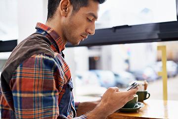 Image showing Man, hands and phone with coffee in social media, communication or networking at indoor cafe. Male person on mobile smartphone for online chatting, texting or app by window at restaurant or cafeteria