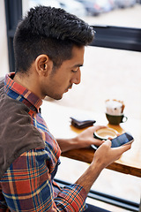 Image showing Man, coffee and typing with phone for social media, communication or networking at indoor cafe. Male person on mobile smartphone for online chatting, texting or app by window at cafeteria restaurant