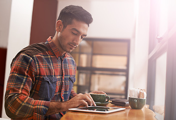 Image showing Man, tablet and typing with coffee for research, social media or online browsing at cafe. Male person or freelancer working on technology for search, scrolling or networking in communication at shop