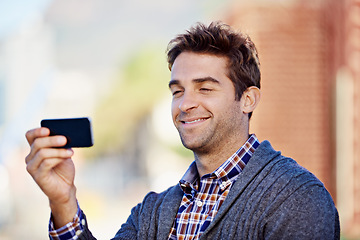 Image showing Photograph, outdoor and man with smartphone, smile and memory with social media and connection. Person, guy in a city and mobile user taking a picture and cellphone with digital app and technology