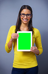 Image showing Woman, tablet and green screen with mockup for studio portrait with presentation, show and ui by blue background. Student, person and digital touchscreen with chromakey for space, app and promotion