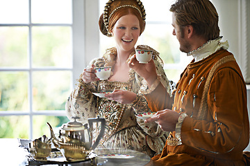 Image showing King, queen and couple with tea at castle, smile and conversation in vintage clothes for royalty at breakfast. Woman, man and drink together in morning with Victorian fashion at regal palace in UK