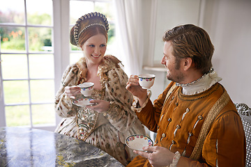 Image showing King, queen and couple with tea in castle, smile and conversation in vintage clothes with luxury at breakfast. Woman, man and drink together in morning with Victorian fashion at regal palace in UK