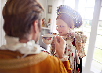 Image showing Man, woman and royal costume for tea party with conversation, vintage clothes and style in castle. King, queen and couple with drink together in morning with Victorian fashion at regal palace in UK