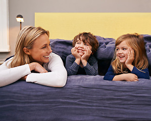 Image showing Home, mother and kids in bed with love, support and bonding together with a smile. Happy, family and children with mom in the morning in the bedroom relax with youth in a house with parenting