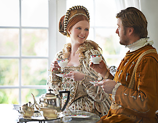 Image showing King, queen and tea for royalty in castle, smile and conversation in vintage clothes with style at breakfast. Woman, man and drink together in morning with Victorian fashion at regal palace in UK