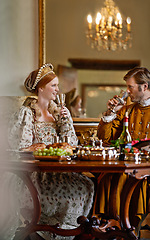 Image showing Queen, king and couple with wine, happy and relax together at dinner, celebration or party in royal mansion. Woman, man and smile with glass, alcohol or drink with food for event in Victorian palace