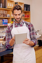 Image showing Man, barista and tablet for reading in coffee shop with smile, thinking or communication for online order. Person, waiter and digital touchscreen for typing, click or check for ecommerce in cafeteria