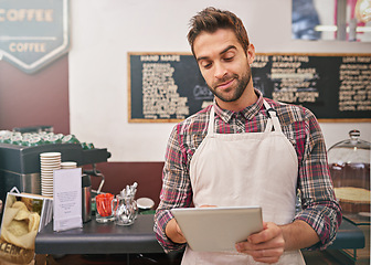 Image showing Man, barista and tablet for typing in coffee shop with smile, thinking or communication for online order. Person, waiter and digital touchscreen for reading, click or check for ecommerce in cafeteria