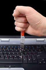 Image showing Hand with a knife in the laptop keyboard