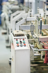 Image showing Factory, production and machine closeup with technology in system at manufacturing warehouse. Industrial, process and press button or click on panel for construction or development in productivity