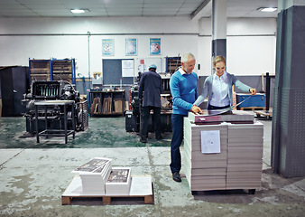 Image showing Printing, warehouse and man and woman with paper for teamwork, collaboration or product inspection. Factory, supply chain and people for logistics, manufacturing and industrial production in workshop