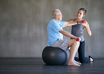 Image showing Physiotherapist, dumbbells and smile of senior man on ball for fitness or rehabilitation at gym on mockup. Elderly person, weightlifting and personal trainer help for body health or physical therapy