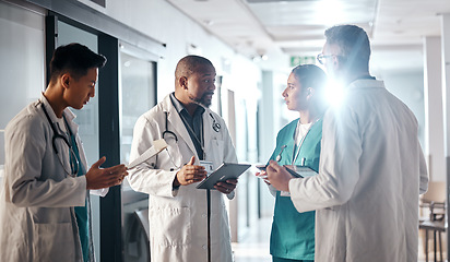 Image showing Hospital, teamwork and doctors with tablet, conversation and brainstorming for healthcare and administration. Medical, nurse and senior professional with group and meeting with folder, help or advice