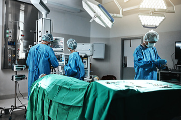 Image showing Doctor, surgeon and employees in hospital, theater and emergency room busy in medical career. People, healthcare workers and nurses with patient for surgery, medicine and operation for health