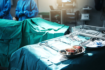 Image showing Surgery, table and equipment for procedure in hospital for medical transplant treatment. Healthcare, scissors and blur of surgeons working with metal surgical tools for operation at medicare clinic.