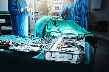 Image showing Surgery, table and equipment for operation in hospital for medical transplant treatment. Healthcare, scissors and blur of surgeons working with metal surgical tools for people and procedure at clinic