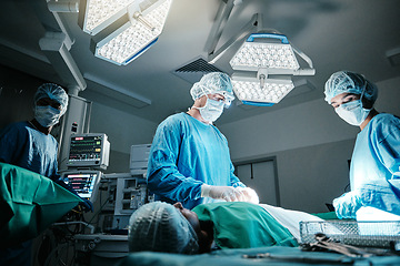 Image showing Doctor, surgeon and patient in hospital, theater and emergency room busy with operation in medical career. Healthcare, nurse and workers with staff for surgery, medicine and health in clinic