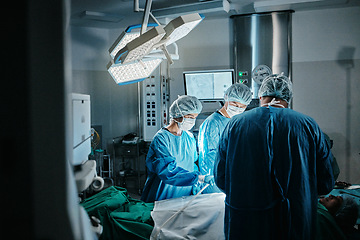 Image showing Surgery, icu or surgeons with teamwork for emergency, accident or healthcare in hospital clinic. Light, medical operation or doctors in surgical collaboration in operating room to support or help