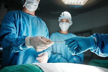 Image showing Surgeon, hands and scalpel in operating room at hospital in scrubs, ppe or emergency healthcare procedure. Doctors, group and together in icu, medical surgery or tools for help for wellness at clinic