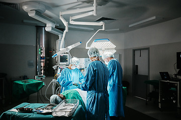 Image showing Surgery, theatre or surgeons with teamwork for emergency, accident or healthcare in hospital clinic. Light, medical operation or doctors in surgical collaboration in operating room to support or help