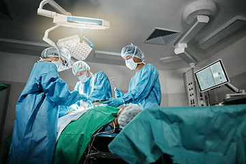 Image showing Healthcare, surgery and doctors with patient for emergency medical procedure in theater. Hospital, lights and surgical team for operation on person together in ICU, professional support and help.