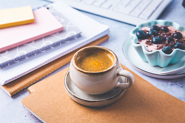 Image showing Coffee break in a office, cup of coffee with healthy yogurt in a office. 