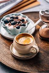 Image showing Coffee break in a office, cup of coffee with healthy yogurt in a office. 