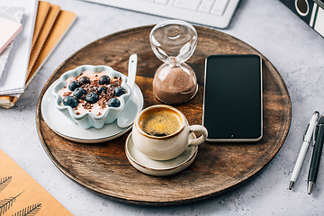 Image showing Coffee break in a office, cup of coffee with healthy yogurt in a office. 