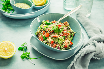 Image showing Tabbouleh salad. Fresh homemade Tabouli salad with fresh parsley, onions, tomatoes and hempseeds