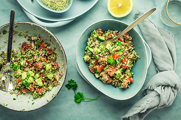 Image showing Tabbouleh salad. Fresh homemade Tabouli salad with fresh parsley, onions, tomatoes and hempseeds