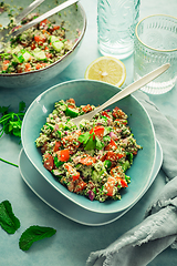 Image showing Tabbouleh salad. Fresh homemade Tabouli salad with fresh parsley, onions, tomatoes and hempseeds