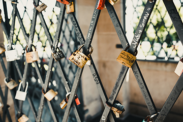 Image showing Vintage locks in soft focus as a symbol of love for friends and lovers. Padlocks are attached to old tower
