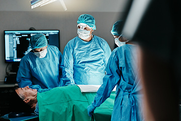 Image showing Medical, surgery or doctors in operating room with theater patient or trauma unit for anatomy emergency. Healthcare, support and surgeon team consulting sick man at hospital with empathy and comfort