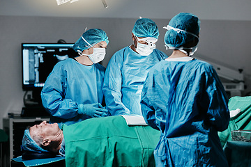 Image showing Healthcare, surgery and team of doctors with patient in theater for emergency medical procedure. Hospital, cooperation and professional surgical staff for operation on senior person together in ICU