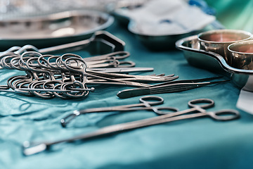 Image showing Medical, surgery and steel tools for hospital care in sterile theater with forceps in operating room, clamps or scissors. Equipment, scalpel and table for surgical procedure, healthcare or wellness