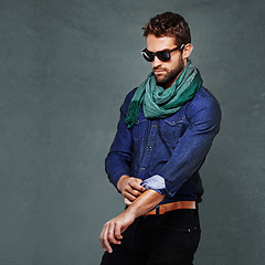 Image showing Fashion, serious and man or model in studio isolated on a gray background mockup space. Confidence, person and roll sleeve on shirt for style in casual clothes, trendy or cool sunglasses with jeans