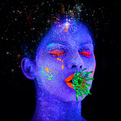 Image showing Neon, paint and face of creative woman in studio with plant for organic art, psychedelic aesthetic or cosmetics. Glow makeup, person or fluorescent glitter for uv illusion or glow on black background