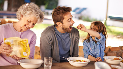 Image showing Happy family, eating and breakfast in garden of home for nutrition, bonding and relax together with porridge. Father, grandma and child with healthy diet, meal and feed at dining table in the morning