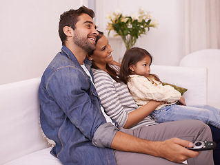 Image showing Family, remote control or fun to relax on sofa, watching tv or cartoon as bonding together in home. Papa, mama or girl child on couch to enjoy show, series or broadcast in living room at weekend