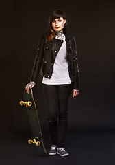 Image showing Fashion, portrait and woman with skateboard in studio for confidence, edgy clothes and satisfaction. Skater, pride and person with tattoos for rebel, grunge style and gen z on black background