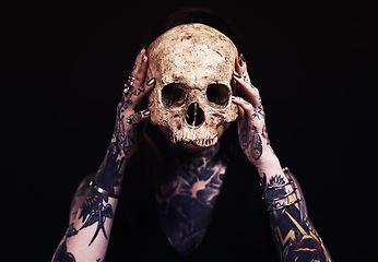 Image showing Skull, art and woman with tattoo in studio for dark magic, horror or scary aesthetic with object. Creative nightmare, halloween culture and unique person in surreal bone portrait on black background