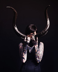 Image showing Horns, demon and woman with tattoo in portrait for dark magic, horror or artistic aesthetic in studio. Creative nightmare, halloween culture and unique person with scary bones on black background