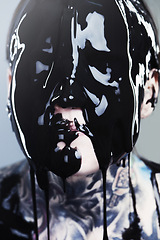 Image showing Abstract, ink and face with black liquid for horror, tattoo and punk art in creative career isolated on gray background. Person, paint and closeup for surreal, unique and grunge on studio backdrop