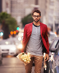 Image showing Man, street and flower for fashion in city outdoor with casual outfit for date night, trends and style. Portrait, confident and urban road in elegant clothes with bouquet in downtown for surprise